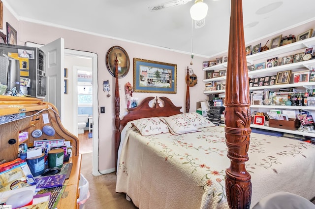 carpeted bedroom with ceiling fan and ornamental molding