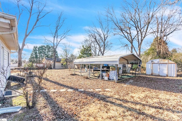 view of yard with a carport and a shed