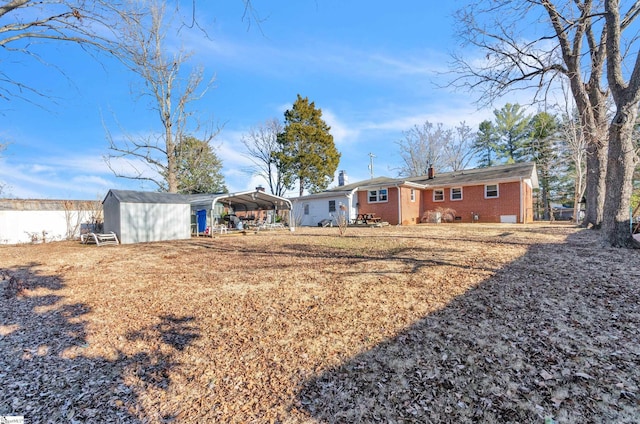 view of yard featuring a shed and a carport