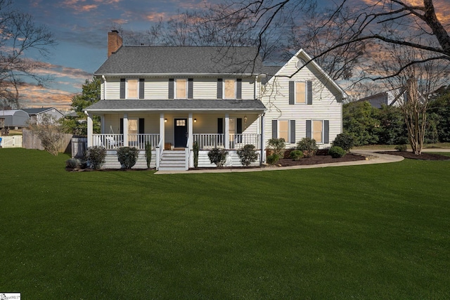 view of front of home with a yard and covered porch