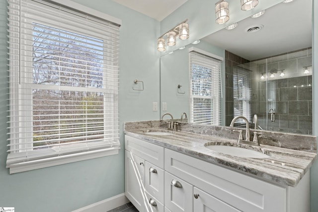 bathroom with an enclosed shower, vanity, and tile patterned floors