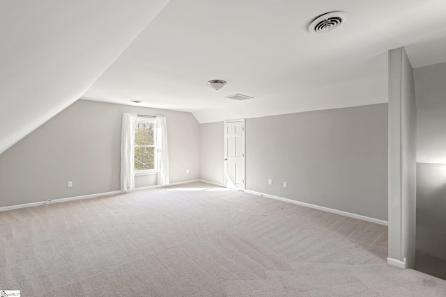 bonus room featuring lofted ceiling and light colored carpet