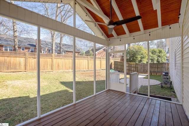 unfurnished sunroom with wood ceiling, lofted ceiling with beams, and ceiling fan