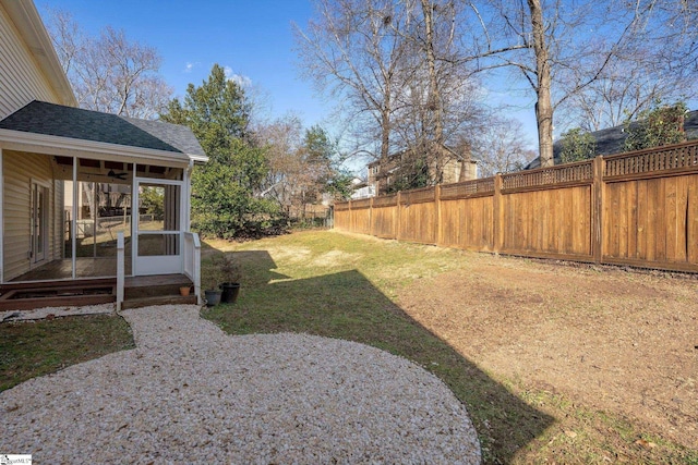 view of yard featuring a sunroom and a patio area