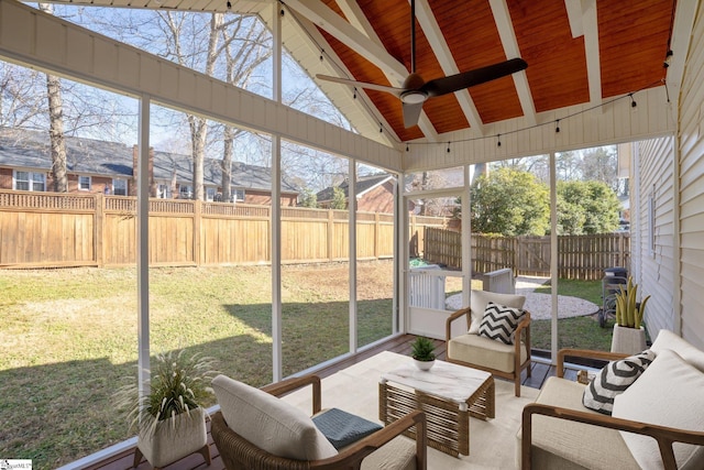 sunroom / solarium featuring vaulted ceiling with beams, wooden ceiling, and ceiling fan