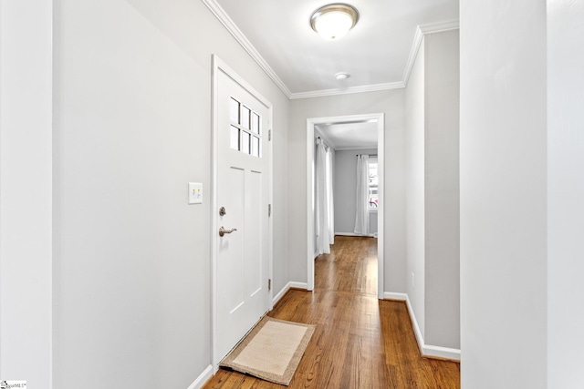 corridor with wood-type flooring and ornamental molding