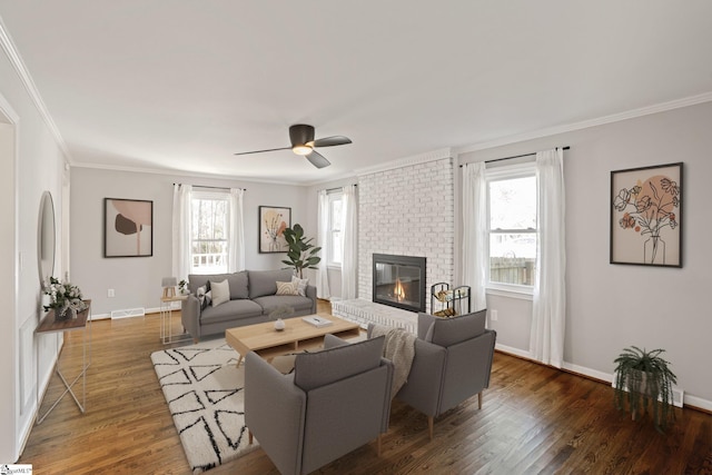 living room featuring ornamental molding, dark hardwood / wood-style floors, and a healthy amount of sunlight