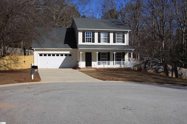 colonial-style house with a garage and covered porch