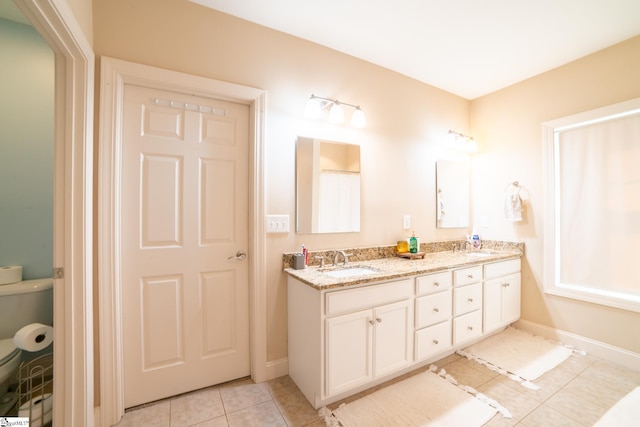 bathroom featuring tile patterned flooring and vanity