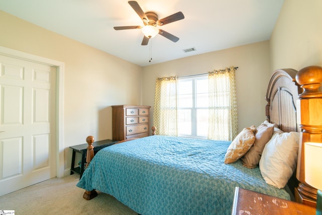 bedroom with ceiling fan and light colored carpet