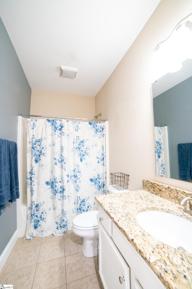 bathroom with tile patterned flooring, vanity, and toilet