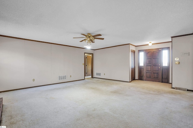 interior space with a textured ceiling, ornamental molding, and ceiling fan