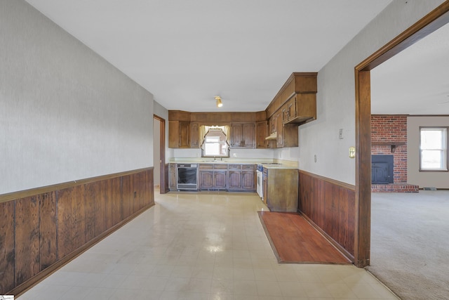 kitchen with range, wooden walls, plenty of natural light, and beverage cooler