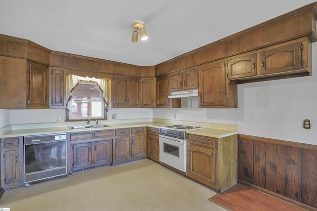 kitchen featuring black dishwasher, sink, and electric range