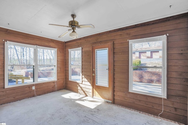 unfurnished sunroom with ceiling fan