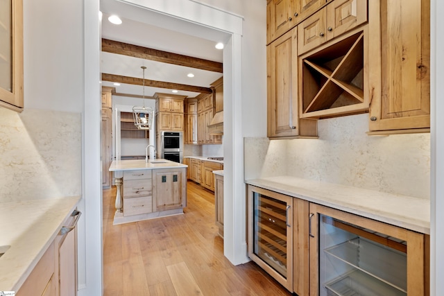 kitchen with wine cooler, tasteful backsplash, hanging light fixtures, beam ceiling, and light hardwood / wood-style floors