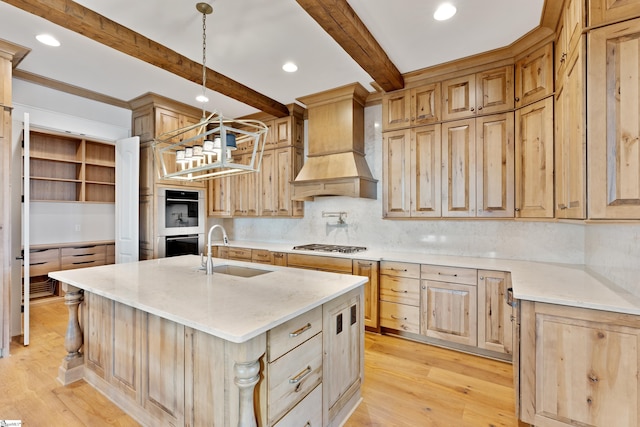 kitchen featuring sink, hanging light fixtures, custom exhaust hood, beamed ceiling, and light wood-type flooring