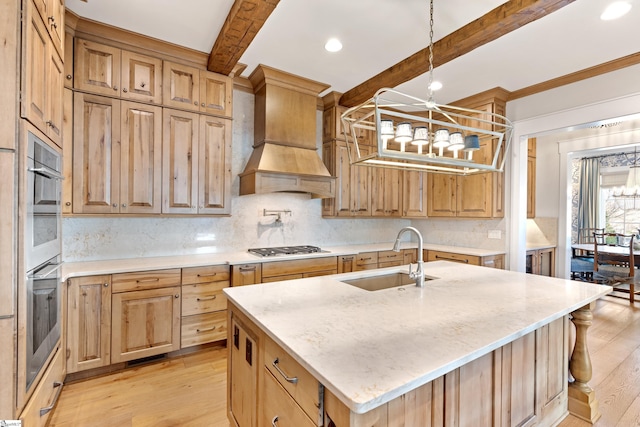 kitchen with sink, light hardwood / wood-style flooring, an island with sink, custom range hood, and beamed ceiling