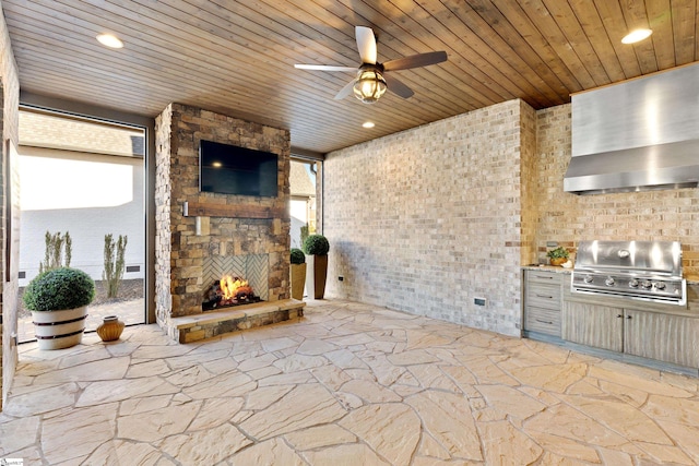 unfurnished living room with an outdoor stone fireplace, brick wall, ceiling fan, and wood ceiling