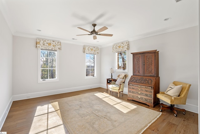 sitting room with crown molding, hardwood / wood-style floors, and ceiling fan