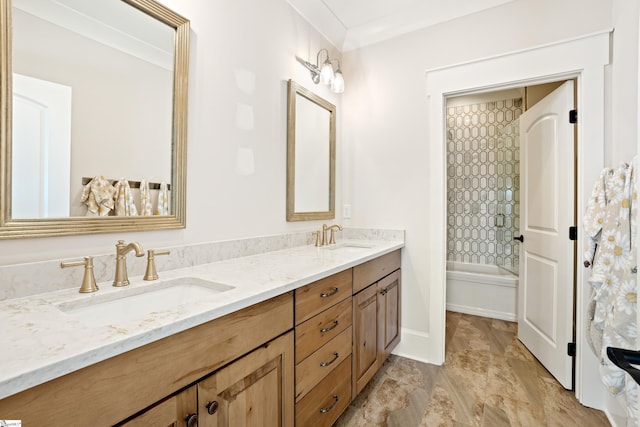 bathroom with ornamental molding, tiled shower / bath combo, and vanity