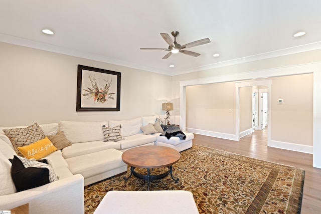 living room with crown molding, hardwood / wood-style floors, and ceiling fan