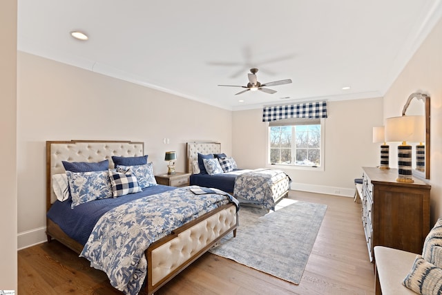 bedroom with wood-type flooring, ornamental molding, and ceiling fan