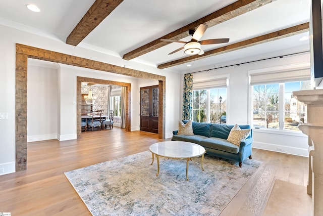 living room with ceiling fan and light wood-type flooring