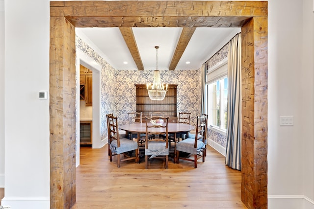 dining room featuring beam ceiling, a chandelier, and hardwood / wood-style floors