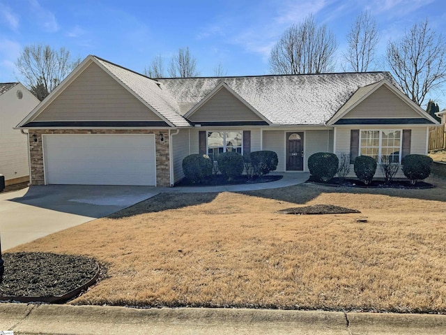 ranch-style house with a garage and a front lawn