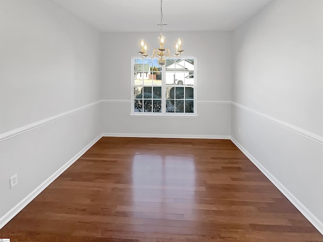 unfurnished dining area with a chandelier and dark hardwood / wood-style flooring