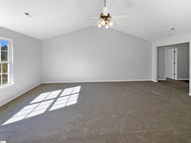 unfurnished room with dark carpet, ceiling fan, and vaulted ceiling