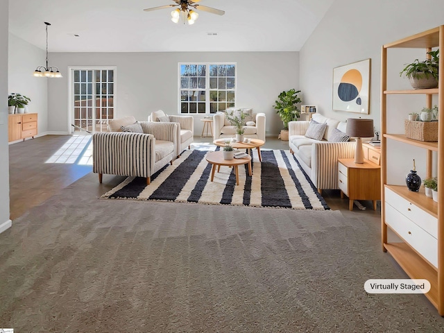 carpeted living room with lofted ceiling and ceiling fan with notable chandelier