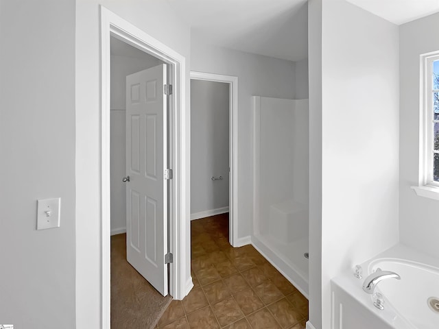 bathroom featuring tile patterned flooring, plenty of natural light, and shower with separate bathtub