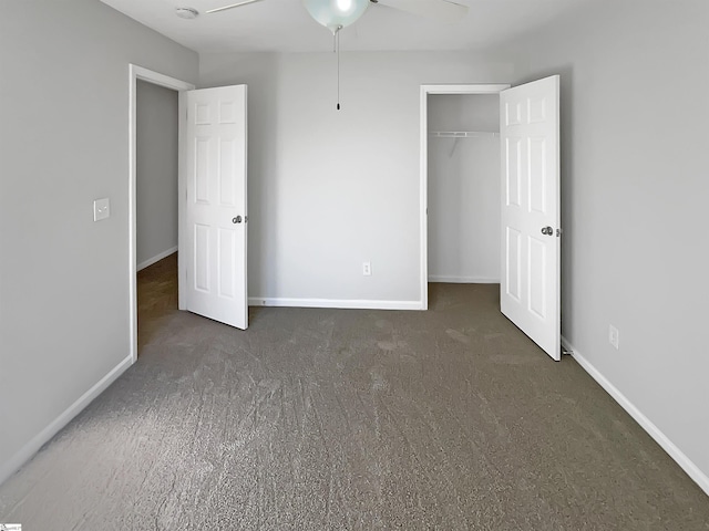 unfurnished bedroom featuring dark carpet, a closet, and ceiling fan