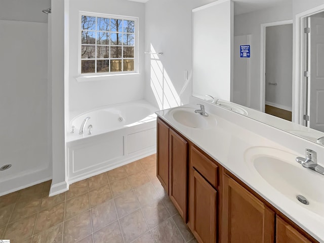 bathroom with tile patterned flooring, a bathing tub, and vanity