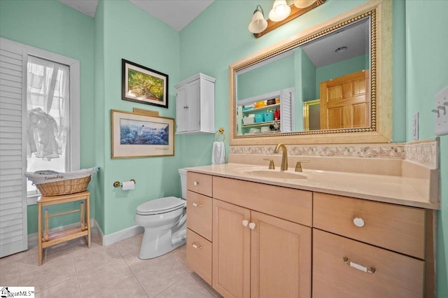 bathroom featuring tile patterned flooring, vanity, and toilet