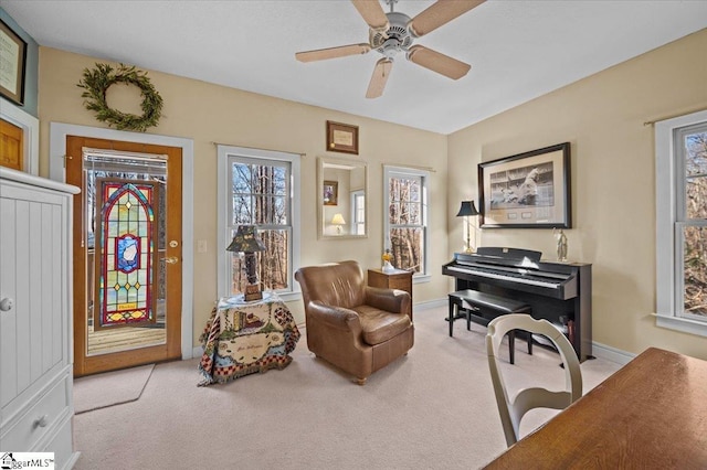 sitting room with ceiling fan and light colored carpet