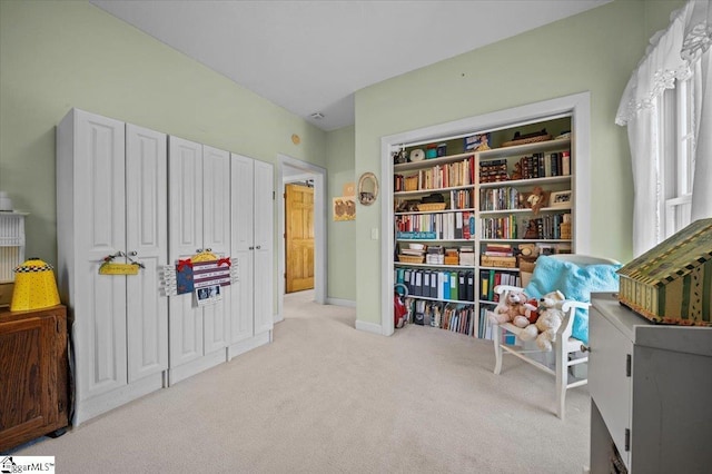 sitting room featuring light colored carpet