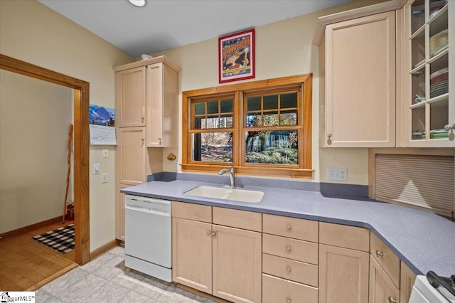 kitchen featuring light brown cabinetry, dishwasher, and sink