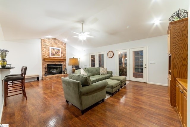 living room featuring french doors, lofted ceiling, dark hardwood / wood-style flooring, ceiling fan, and a fireplace