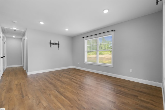 unfurnished room with dark hardwood / wood-style flooring