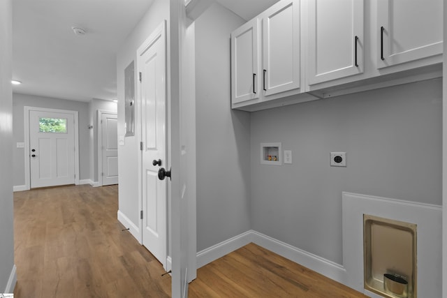 laundry room with washer hookup, light hardwood / wood-style flooring, cabinets, and hookup for an electric dryer