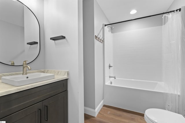 full bathroom with shower / tub combo, vanity, toilet, and hardwood / wood-style floors