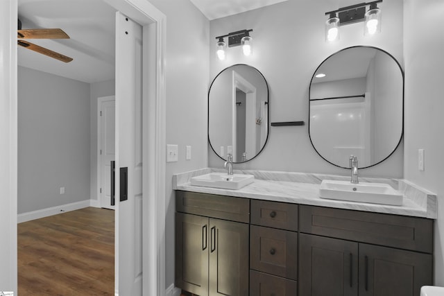 bathroom featuring ceiling fan, vanity, and hardwood / wood-style floors