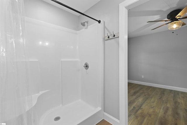 bathroom with hardwood / wood-style flooring, ceiling fan, and a shower with shower curtain