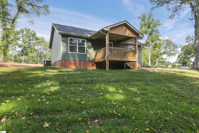 rear view of house featuring a wooden deck and a yard