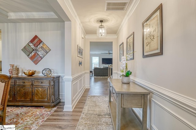 hallway with crown molding and hardwood / wood-style flooring