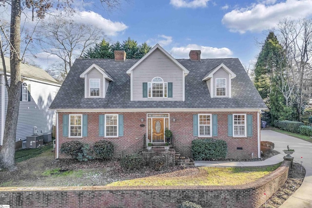 new england style home with central air condition unit