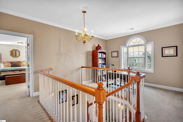 hall featuring an inviting chandelier, ornamental molding, and light carpet